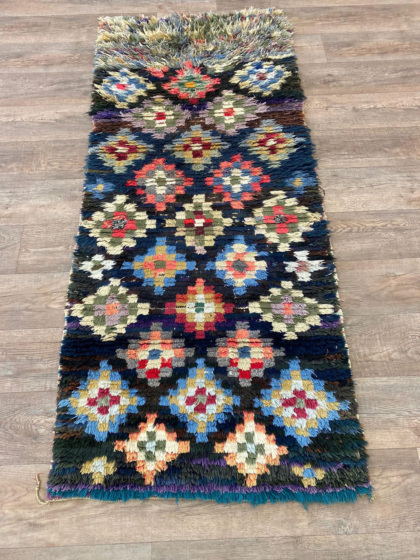 Narrow checkered colorful 3x7 runner rug.