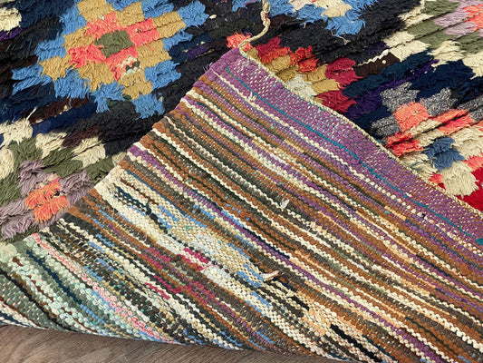 Narrow checkered colorful 3x7 runner rug.
